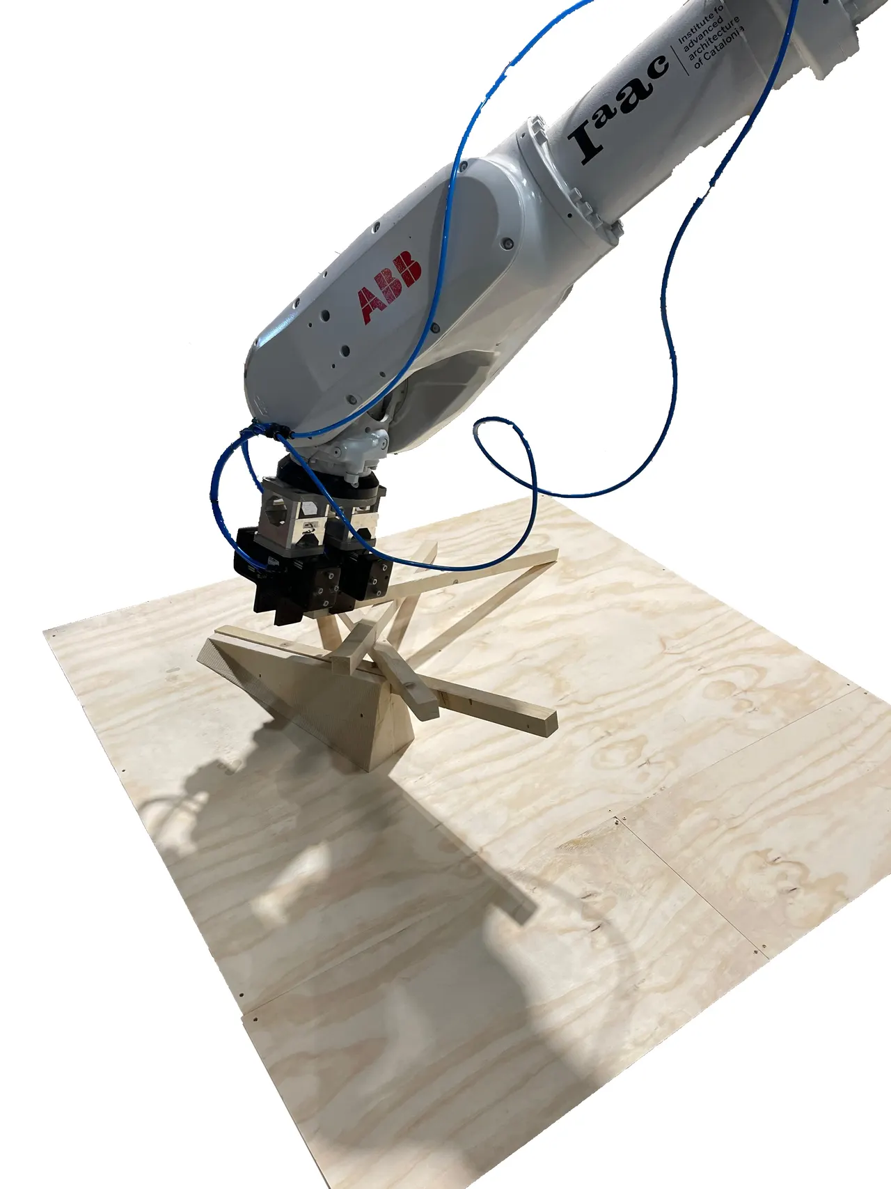 An ABB robot arm placing a timber stick on a plywood base