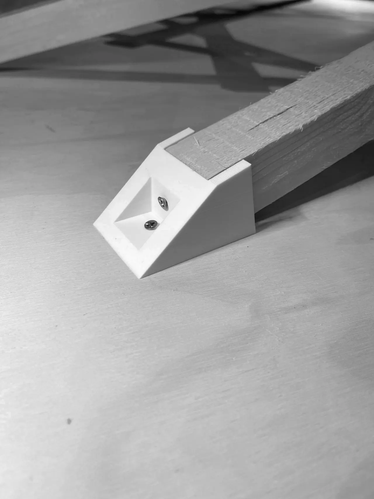 A 3D-printed foot holding the end of a timber stick